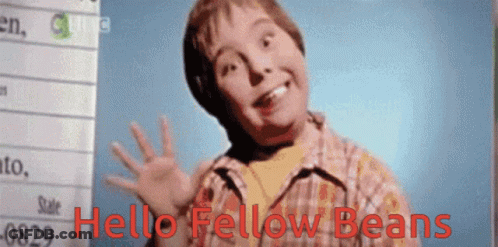 A Young Boy Says Hello Fellow Beans In Front Of A Whiteboard GIF