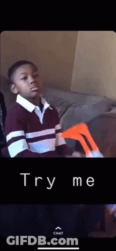 A Young Boy Sitting On A Couch With The Words Try Me Written On The Bottom Of The Screen GIF
