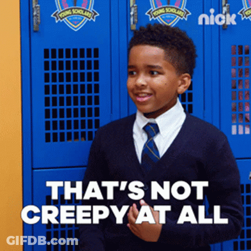 A Young Boy Standing In Front Of Blue Lockers That Say Young Scholars GIF
