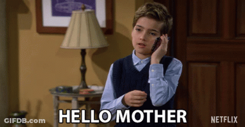 A Young Boy Talking On A Cell Phone With The Words Hello Mother Written On The Bottom GIF