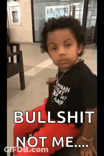 A Young Boy Wearing A Black Shirt And Red Pants Is Sitting In A Chair And Says `` Bullshit Not Me ... '' GIF