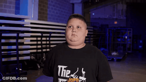 A Young Boy Wearing A Black T-Shirt That Says The Godfather On It GIF