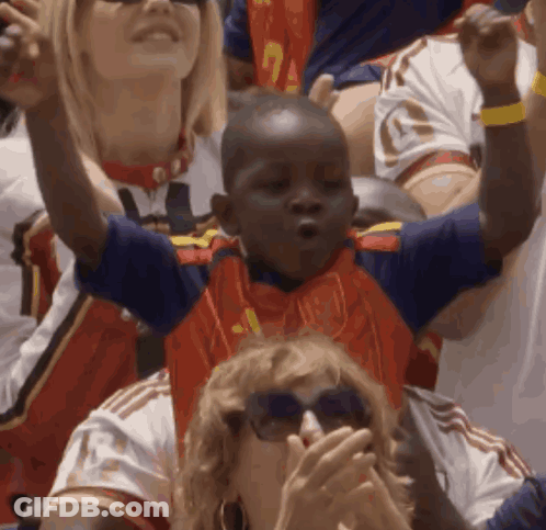 A Young Boy Wearing A Blue And Red Jersey With The Number 1 On It GIF