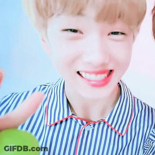 A Young Boy Wearing A Blue And White Striped Shirt Is Smiling GIF