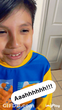 A Young Boy Wearing A Blue And Yellow Shirt Is Smiling With The Words Aaahhhhh !!! Visible GIF