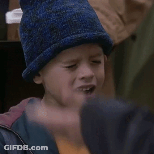 A Young Boy Wearing A Blue Hat And A Jacket GIF
