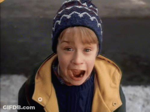 A Young Boy Wearing A Blue Hat And A Yellow Jacket GIF