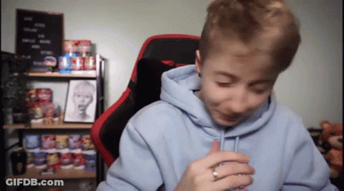 A Young Boy Wearing A Blue Hoodie And A Red Chair GIF