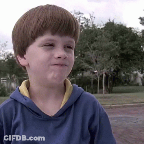 A Young Boy Wearing A Blue Hoodie With A Yellow Collar GIF