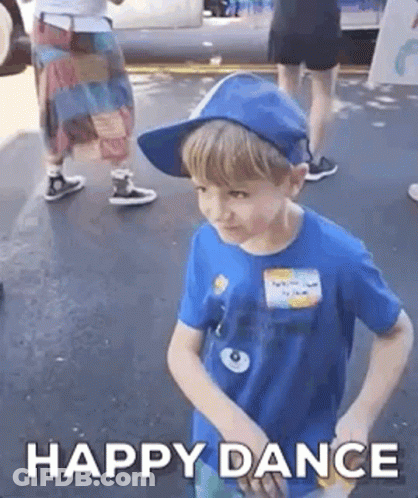A Young Boy Wearing A Blue Shirt And A Blue Hat Is Dancing . GIF