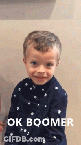 A Young Boy Wearing A Blue Shirt That Says Ok Boomer On It GIF