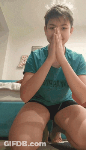 A Young Boy Wearing A Blue Shirt That Says Virraw On It GIF