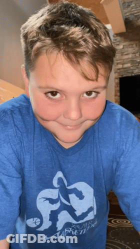 A Young Boy Wearing A Blue Shirt That Says Xvii Basketball GIF