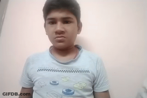 A Young Boy Wearing A Blue Shirt With The Letters Dc On It Makes A Funny Face GIF