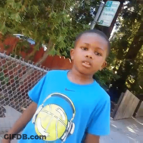 A Young Boy Wearing A Blue T-Shirt With A Basketball And Headphones On It . GIF
