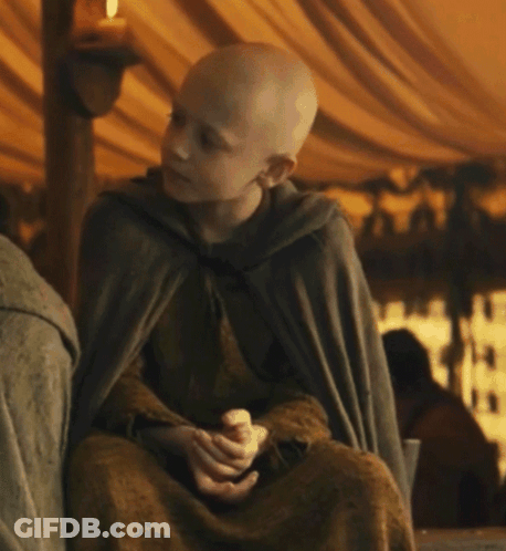 A Young Boy Wearing A Cape Is Sitting In A Tent GIF