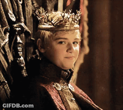 A Young Boy Wearing A Crown Sits On A Throne GIF