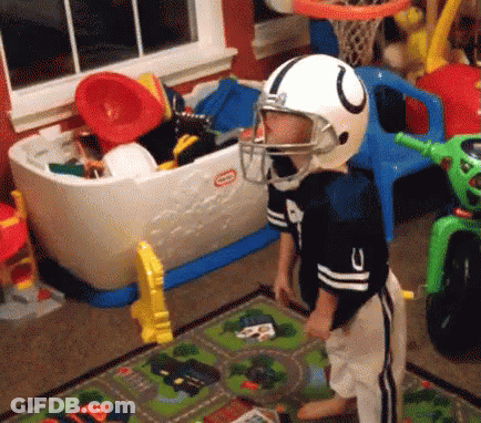 A Young Boy Wearing A Football Helmet And A Little Tikes Toy Chest GIF