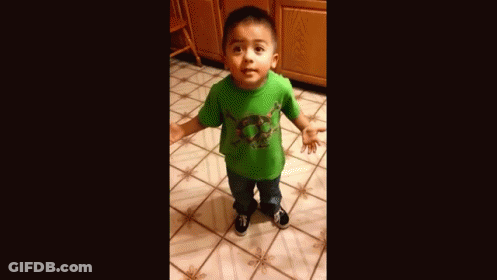 A Young Boy Wearing A Green Shirt Is Standing On A Tiled Floor . GIF