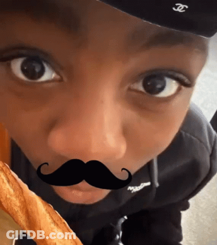 A Young Boy Wearing A Hat And A Fake Mustache GIF