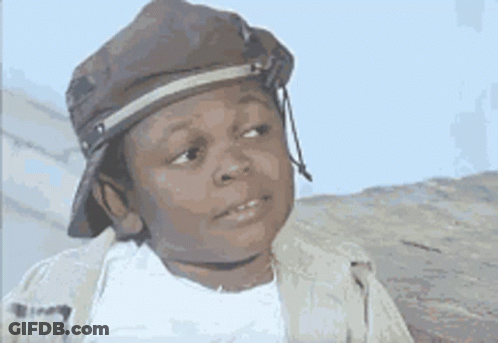 A Young Boy Wearing A Hat And A Jacket Is Making A Face . GIF