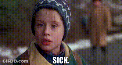 A Young Boy Wearing A Hat And A Jacket Is Standing On A Sidewalk And Says `` Sick '' . GIF