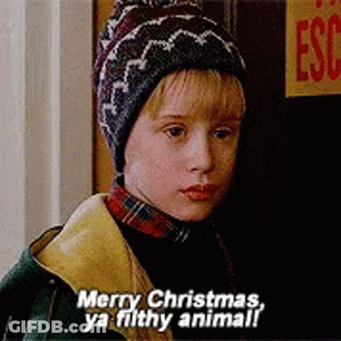 A Young Boy Wearing A Hat And A Plaid Shirt Says Merry Christmas Ya Filthy Animal GIF
