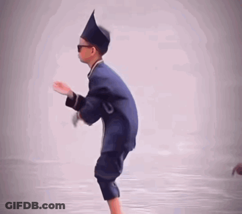 A Young Boy Wearing A Hat And Sunglasses Is Standing On One Leg GIF