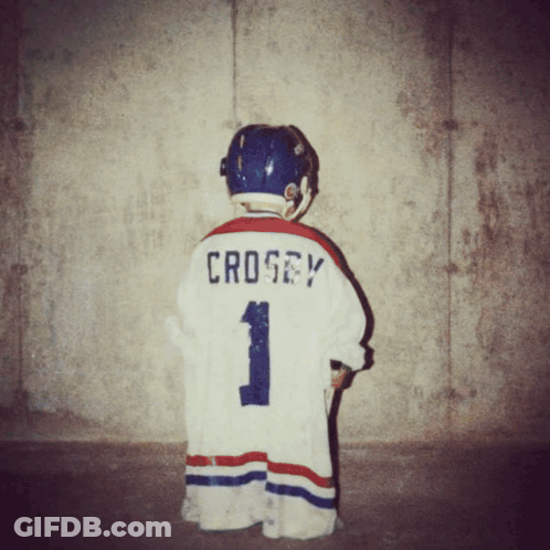 A Young Boy Wearing A Hockey Jersey With The Name Crosby On The Back GIF