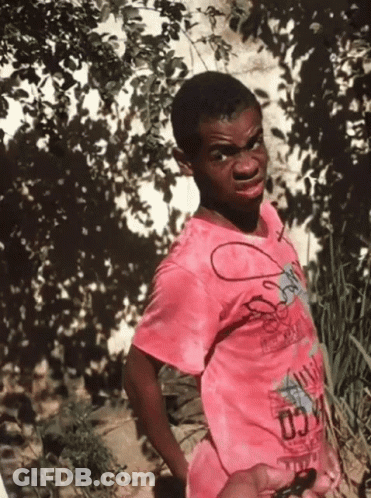 A Young Boy Wearing A Pink Shirt That Says Chicago GIF