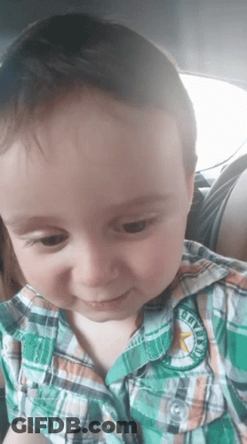 A Young Boy Wearing A Plaid Shirt Has A Patch On His Shirt That Says Cowboys GIF