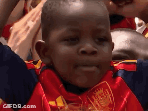 A Young Boy Wearing A Red And Blue Jersey With A Shield On It GIF