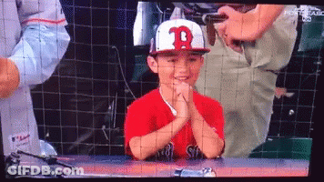 A Young Boy Wearing A Red Shirt And A White Hat With The Letter B On It GIF