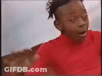 A Young Boy Wearing A Red Shirt Is Making A Funny Face . GIF