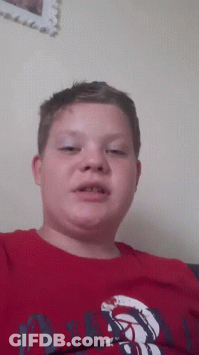 A Young Boy Wearing A Red Shirt That Says ' Abercrombie & Fitch ' On It GIF