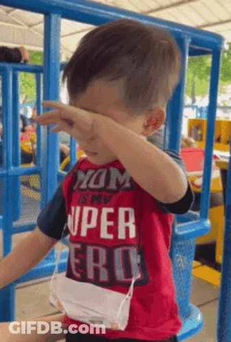 A Young Boy Wearing A Red Shirt That Says " Mom Is My Super Hero " GIF