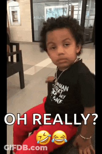 A Young Boy Wearing A Shirt That Says " Oh Really " GIF