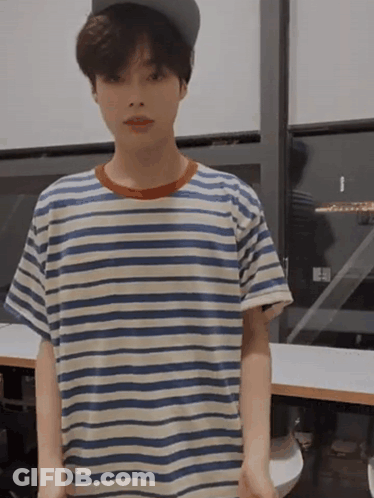 A Young Boy Wearing A Striped Shirt And A Hat GIF