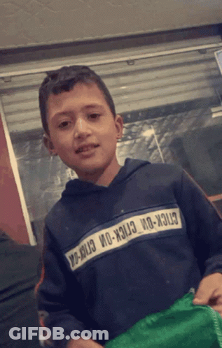 A Young Boy Wearing A Sweatshirt That Says Stick-On-Stick-On-Stick-On GIF