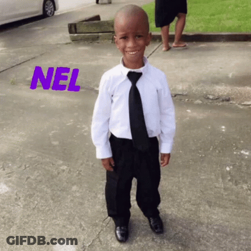 A Young Boy Wearing A White Shirt And Black Tie Is Standing On A Sidewalk With The Word Nel Above Him GIF