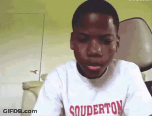 A Young Boy Wearing A White Shirt With Souderton On It GIF
