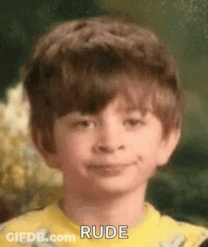 A Young Boy Wearing A Yellow Shirt Is Making A Rude Face . GIF