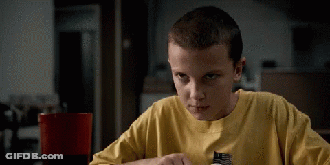 A Young Boy Wearing A Yellow Shirt Is Sitting At A Table . GIF