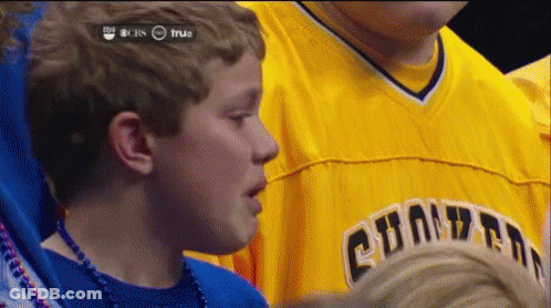 A Young Boy Wearing A Yellow Shirt That Says Champions On It GIF