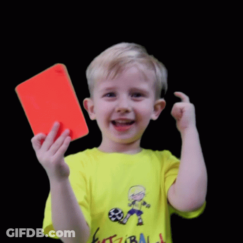 A Young Boy Wearing A Yellow Shirt That Says Futzibali Holds A Red Card GIF