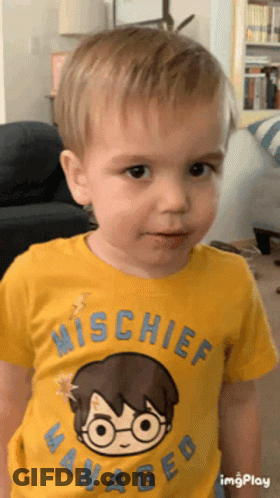 A Young Boy Wearing A Yellow Shirt That Says Mischief Managed On It GIF