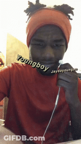 A Young Boy Wearing An Orange Headband Is Holding A Pair Of Earbuds GIF