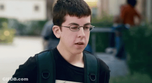 A Young Boy Wearing Glasses And A Black Shirt GIF