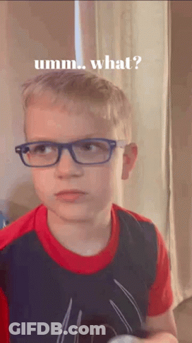 A Young Boy Wearing Glasses And A Spiderman Shirt Is Making A Funny Face And Asking What . GIF