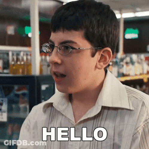 A Young Boy Wearing Glasses And A White Shirt Is Saying Hello GIF